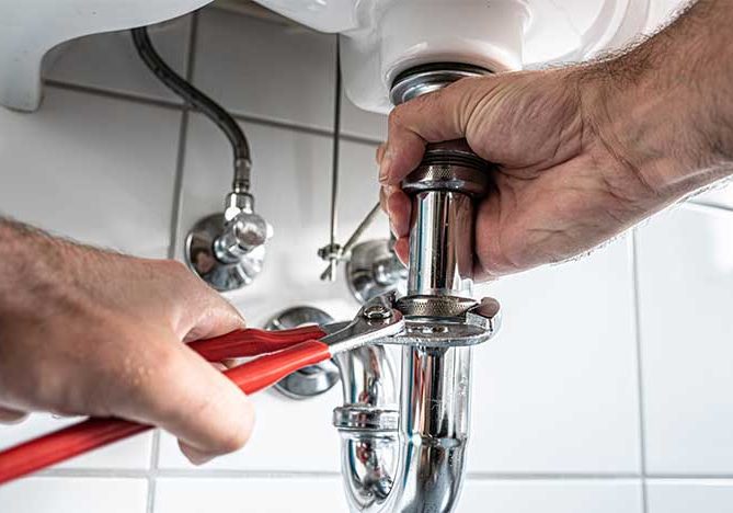 plumber-hands-close-up-repairing-bathroom-sink-pipes-fort-collins-co